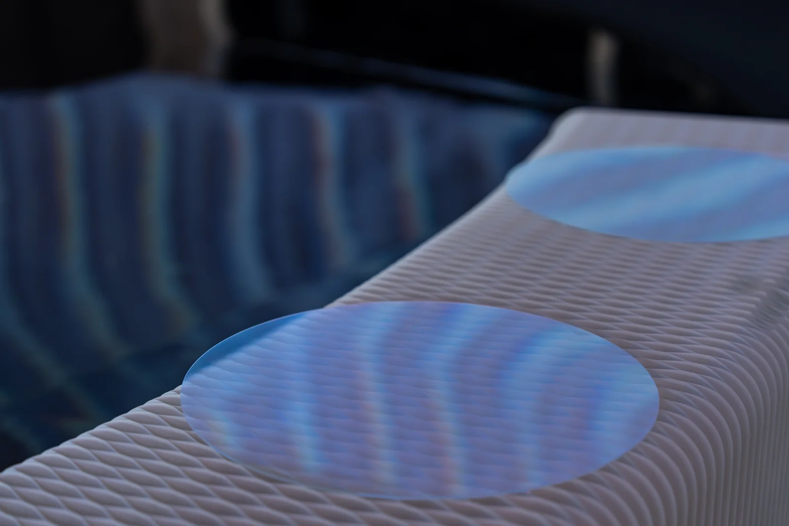 Cymatics of Life on site: Round discs on the bench, catching the ripples from the wall