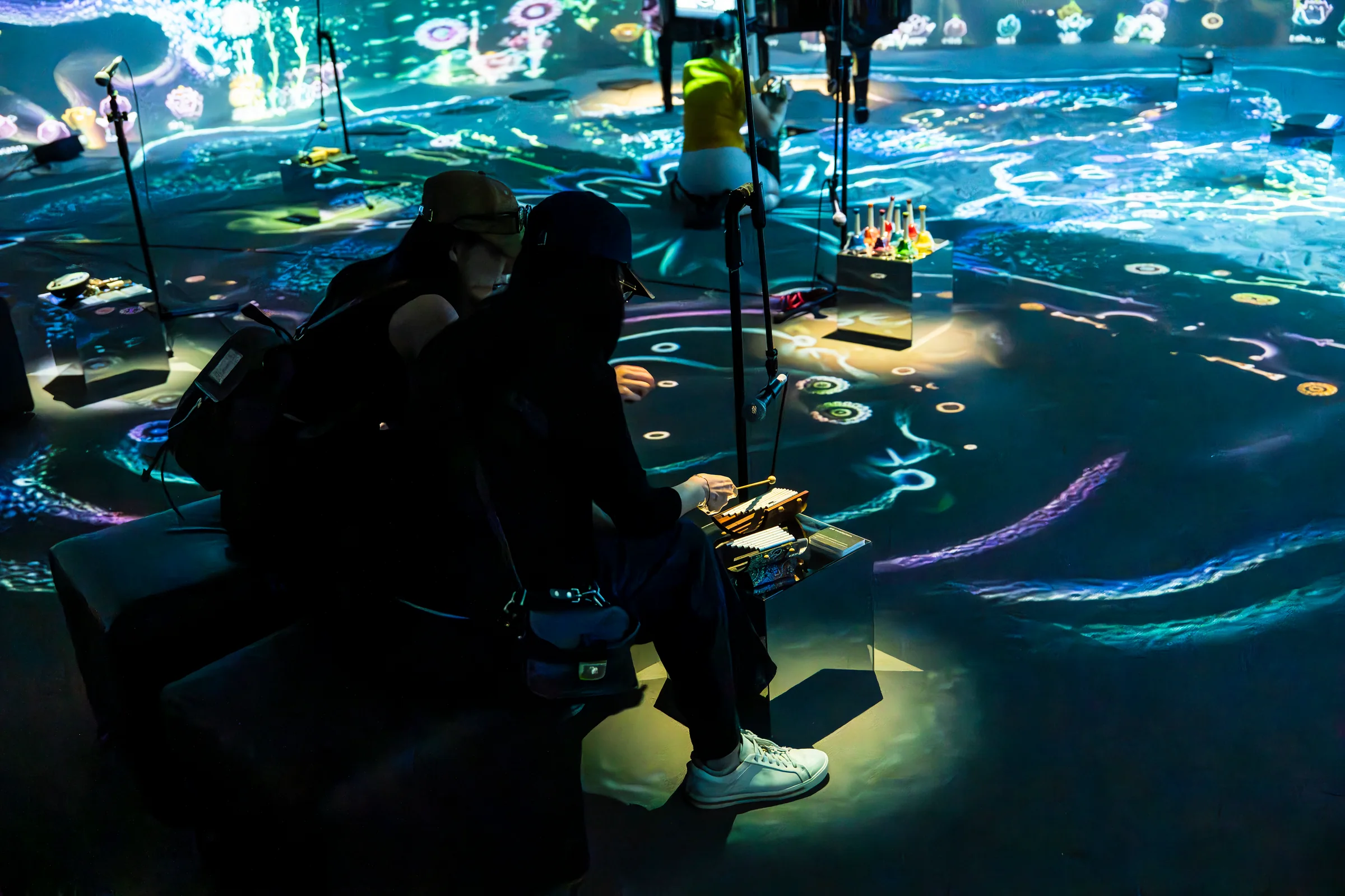 The Eternal Garden in a Bottle, Pier-2, Visitors on the white silica sand, the picture reaching their feet