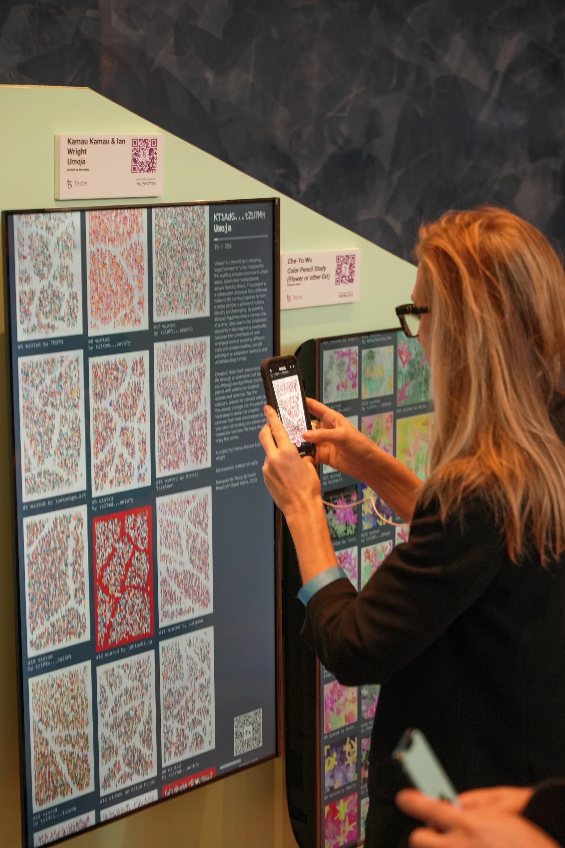 A visitor scanning the code on the wall