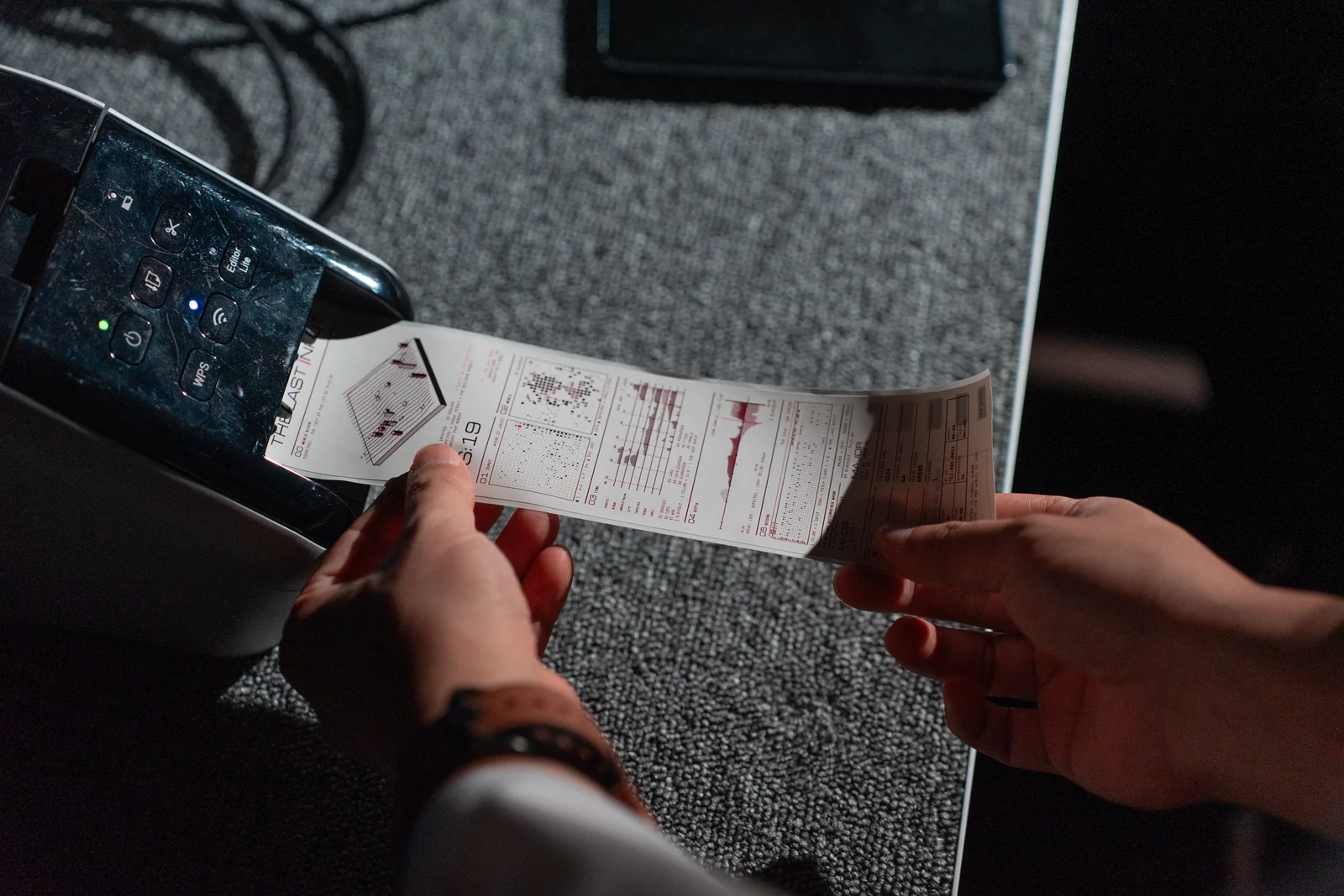 The Last Input rehearsal: two hands tearing off the receipt