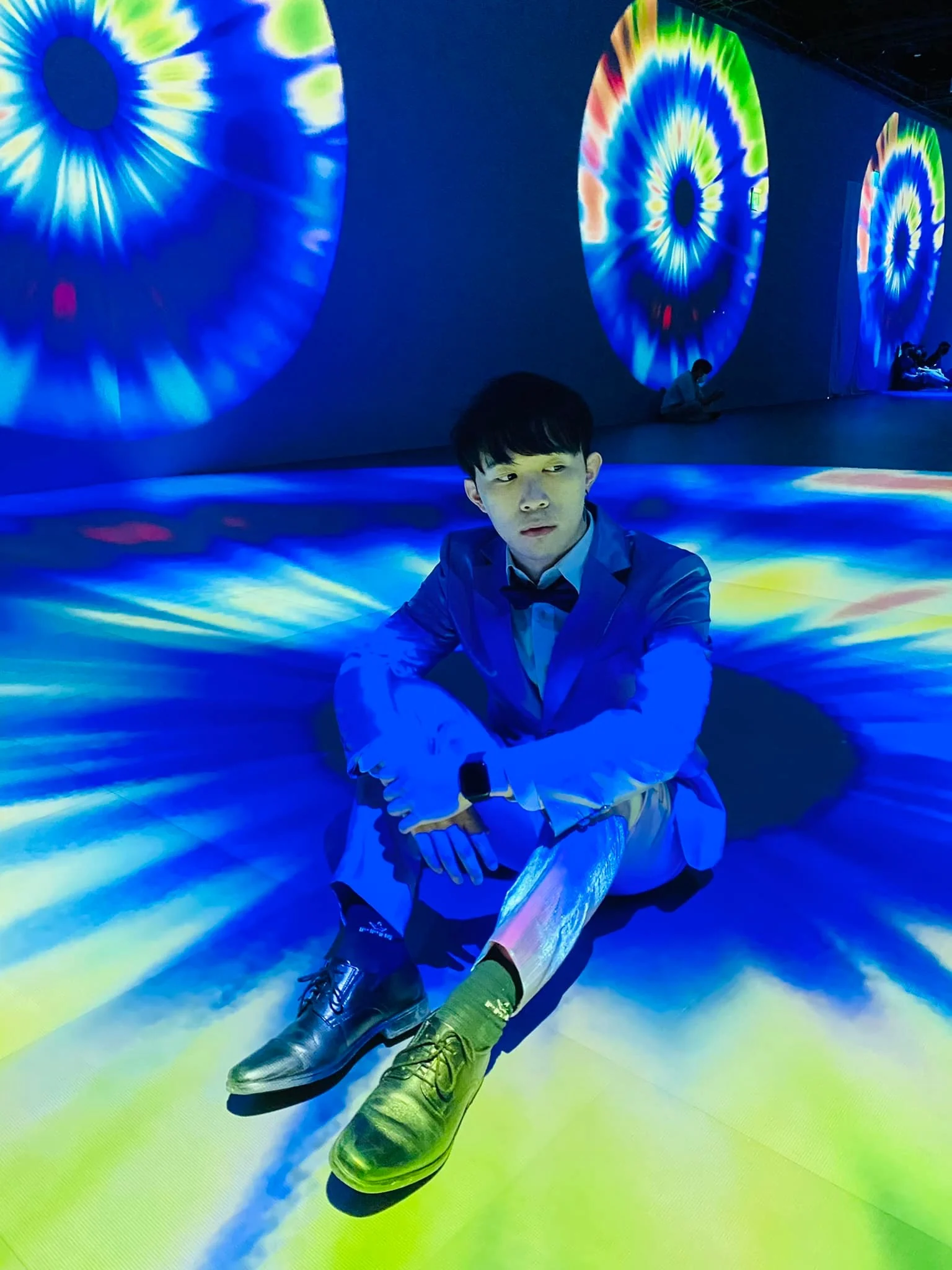 Che-Yu Wu sitting inside the eye on the floor