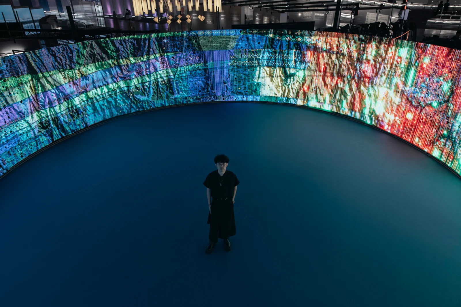 Woven Land, Woven River in the pavilion: One person at the centre, the whole ring of cloth around them